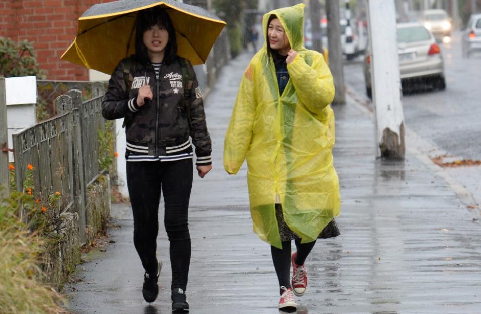 Visitors from China Jun Lin (left) and Cissy Yu make their way along North Rd towards Baldwin St...