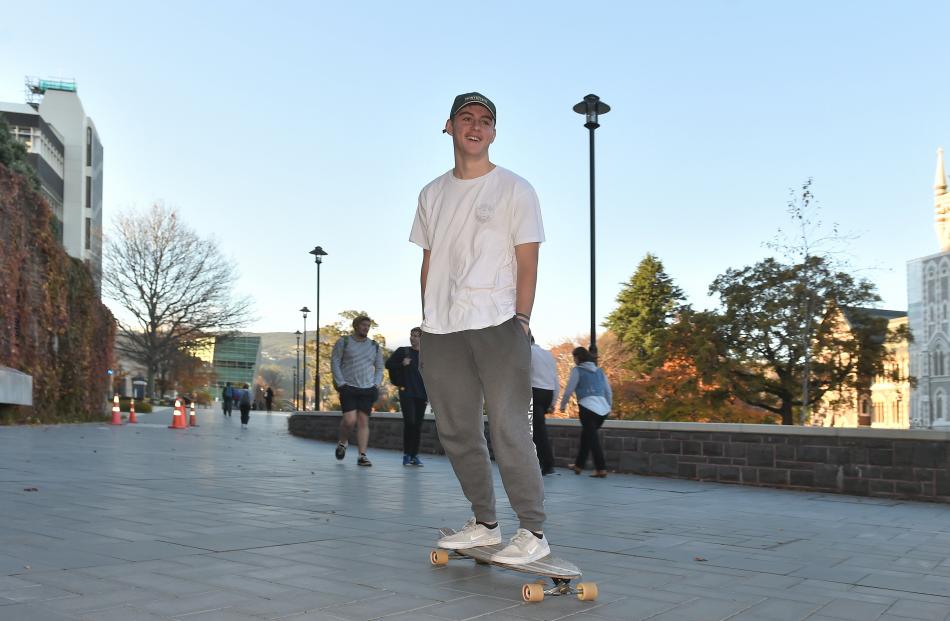 First-year marketing student Harry Webby (18) skates past the Clocktower on his way to a lecture...