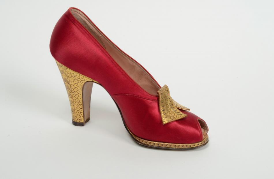Red satin and gold leather shoe by Frank Brothers, Chicago & New York. Gift of the estate of Mrs Joanne Macaulay.