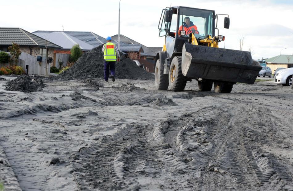 Contractors work to clear a Bexley street of silt yesterday.