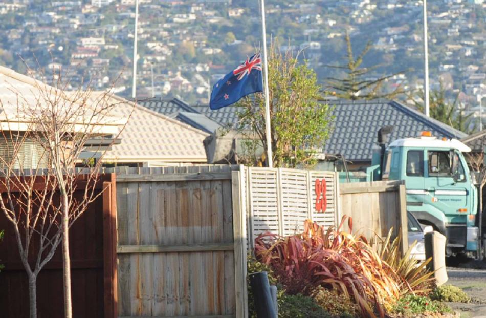 A Bexley resident flies the New Zealand flag at half-mast, after the quake basically destroyed...