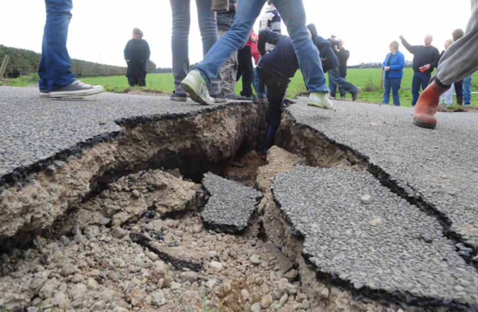 People take a closer look at the damage at the epicentre of the quake, on Highfield Rd near Kirwee.