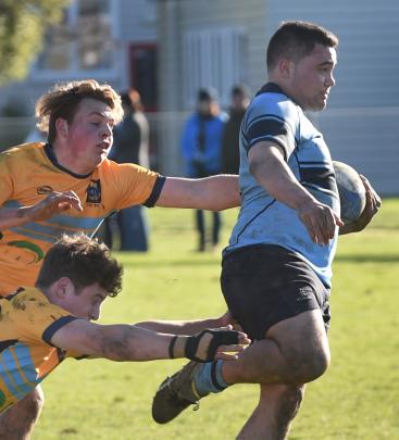 King's High School prop Lemanu Ma'asi is tackled by Taieri College players (from top) Tayne Russell and halfback Bob Martin during the first 15 rugby match at King's High School on Saturday. Photo: Peter McIntosh