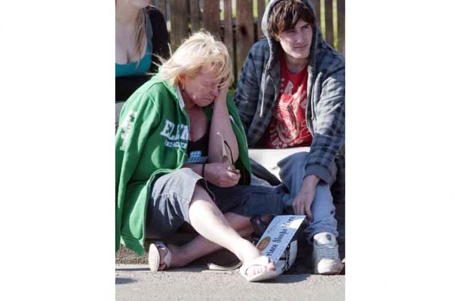 Rose Lennon, left, and son Myles Alexander despair as their shop is torn down in Cranford Street,...