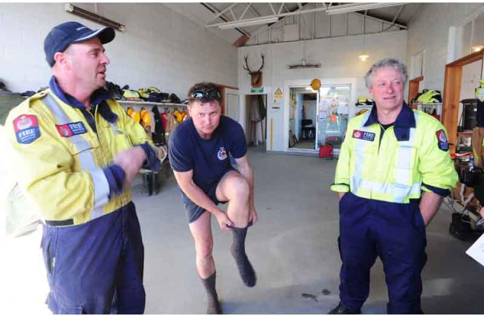 Brooklands volunteer fire fighters Trevor Casey, Murray Burgess and John Reed start to wind down...
