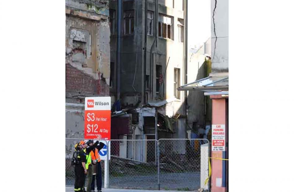 A Urban Search and Rescue member (USAR) inspects cracks in buildings in the catherdal square....