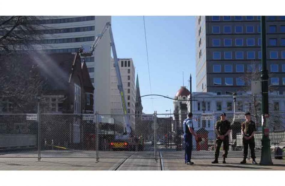 Police and army staff patrol a CBD cordon. Photo by Craig Baxter.