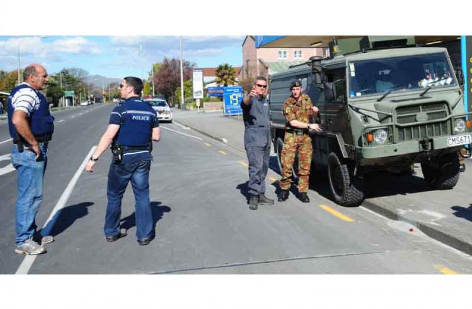 Police and army staff discuss cordons on Cranford Street. Photo by Craig Baxter.