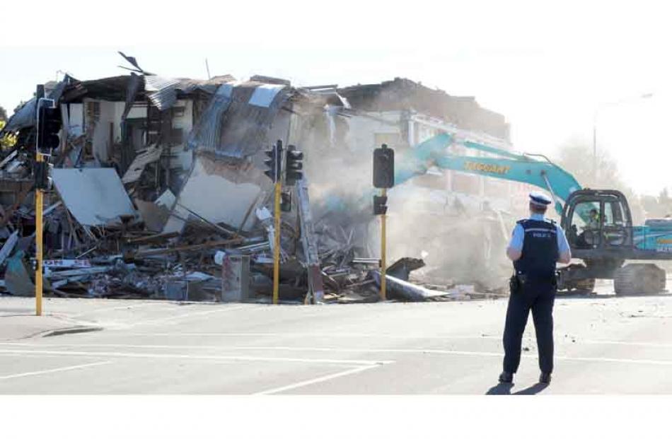A ditchdigger demolishes a row of shops in St Albans, Christchurch, after an aftershock...