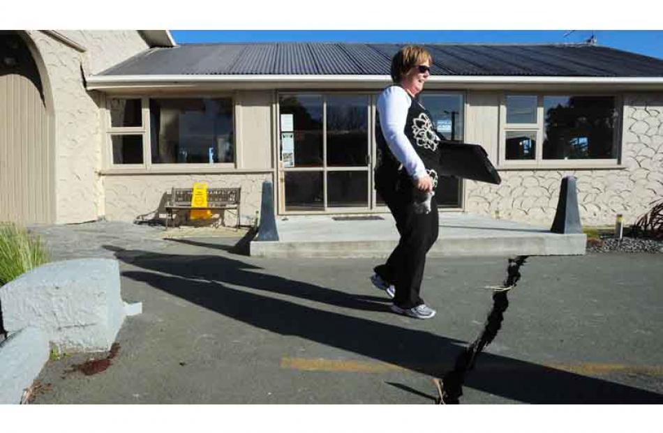 Debbie Riley removes some of the last items from her slowly sibsiding restaurant and bar at...