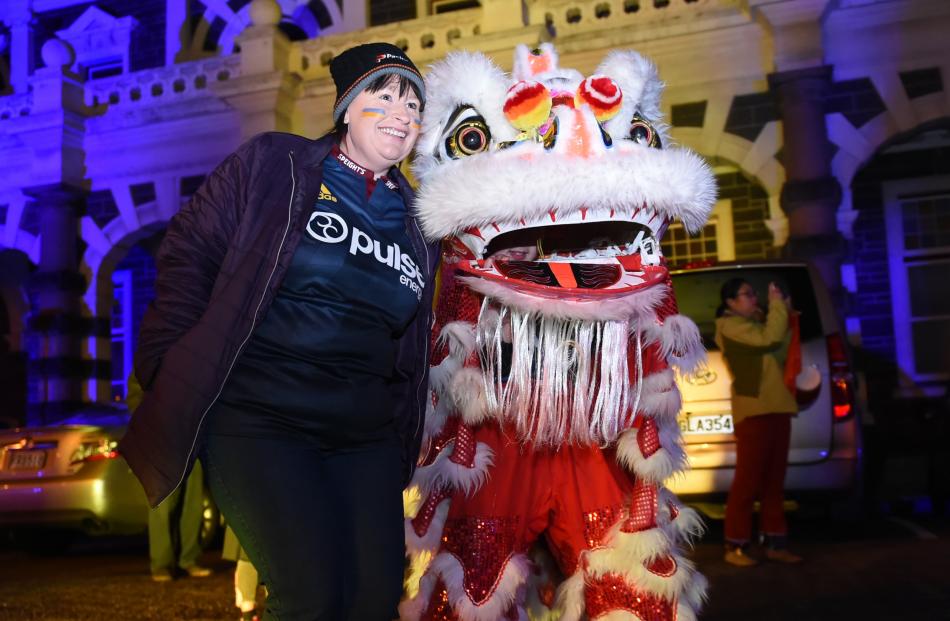 Highlanders fan Corrin McInnes, of Dunedin, poses for a picture with a Chinese dragon at the...