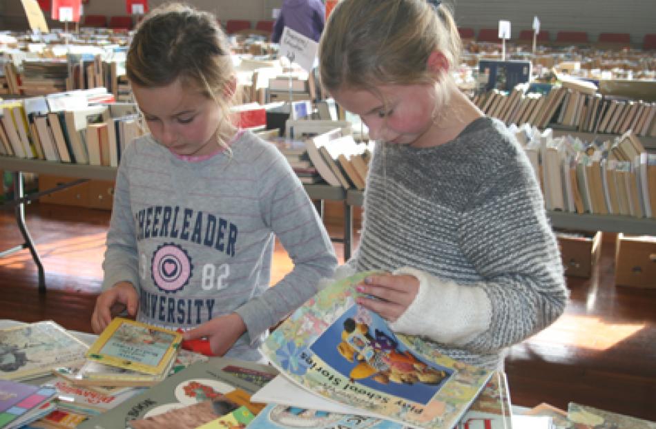 7-year-old Sally and 9-year-old Julie Thompson, of Invercargill, enjoying sorting through the...