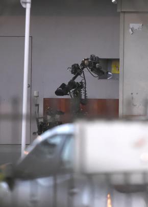 A robot operated by the squad inspects the package before it was destroyed. Photo: Gregor Richardson