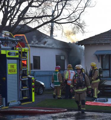 Crews attend a house fire in South Dunedin yesterday. Photos: Peter McIntosh
