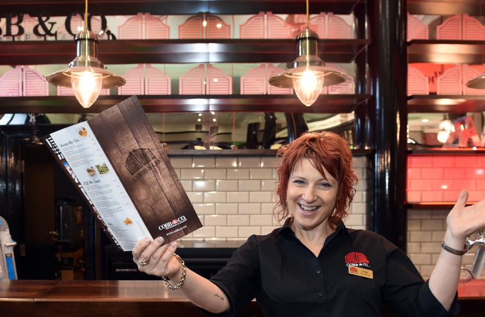 Cobb & Co Dunedin general manager Ange Copson with one of the new Dunedin restaurant's menus. Photos: Peter McIntosh