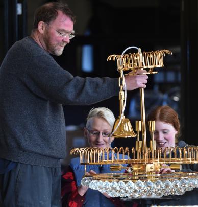Cobb & Co kitchen manager Neill Leitch, shift manager Rhonda Goodwin (centre) and waitress Gemma Park assemble one of the chandeliers.