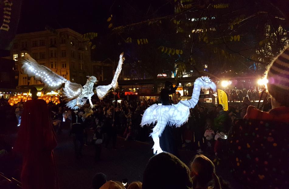 Large light puppets interact with the crowd at the packed octagon. Photo: Vaughan Elder