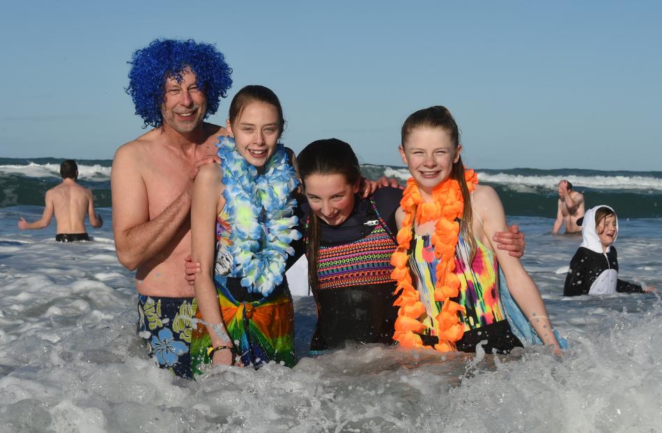 Polar plungers (from left) Mike McConachie, Tessa McConachie (14), Emma Andrews (13) and Annabelle Bilkie (14), all of Dunedin, are all smiles despite the chilling water of St Clair Beach at the 88th Polar Plunge yesterday. Photos: Gregor Richardson