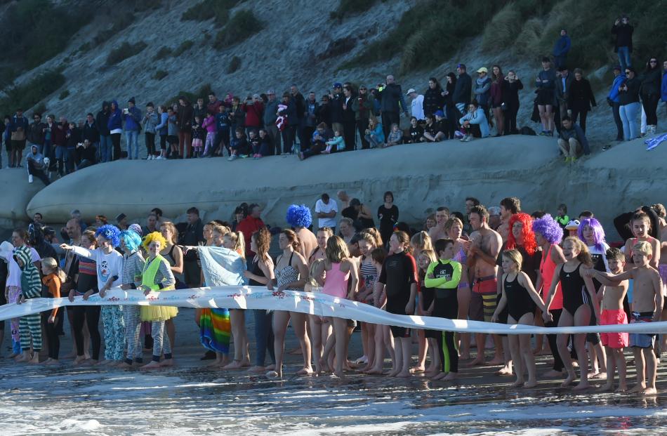 About 300 people braved the winter water temperatures of the Pacific Ocean to take part in the annual event. 