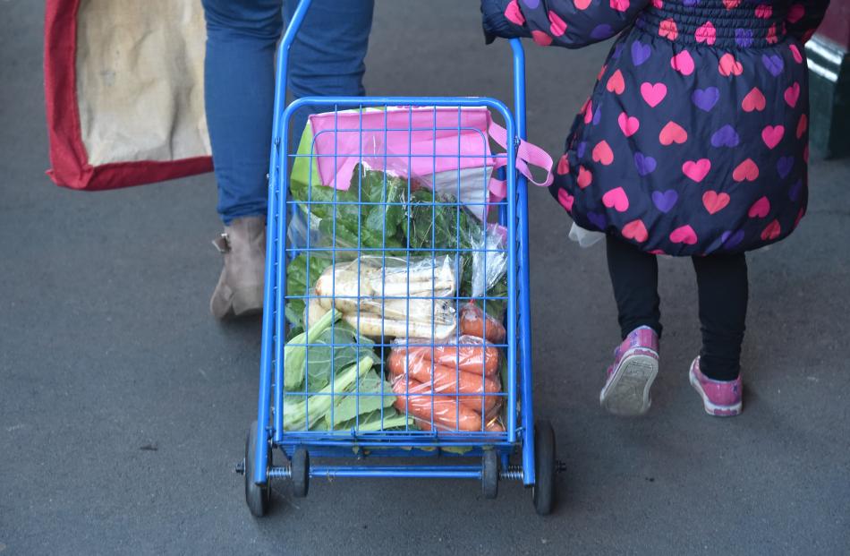 A visitor carries their purchases in a trolley.