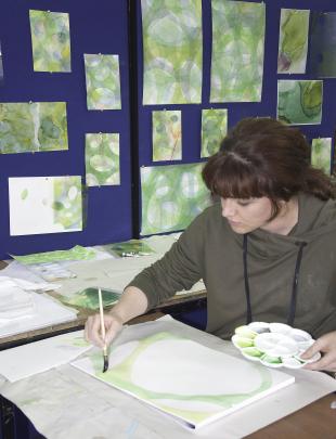 Chanel Taylor works on the watercolours she is creating as part of the Art and Genetics Exhibition. Photos: Supplied