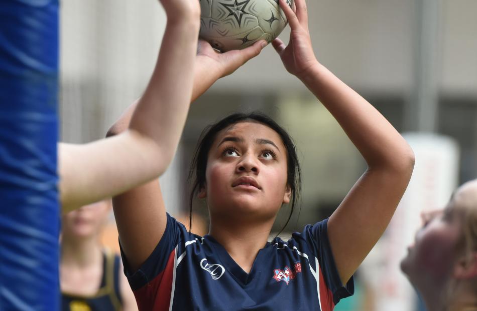 Anita Samasoni (14), of Kavanagh College, shoots during a netball match at the Edgar Centre...