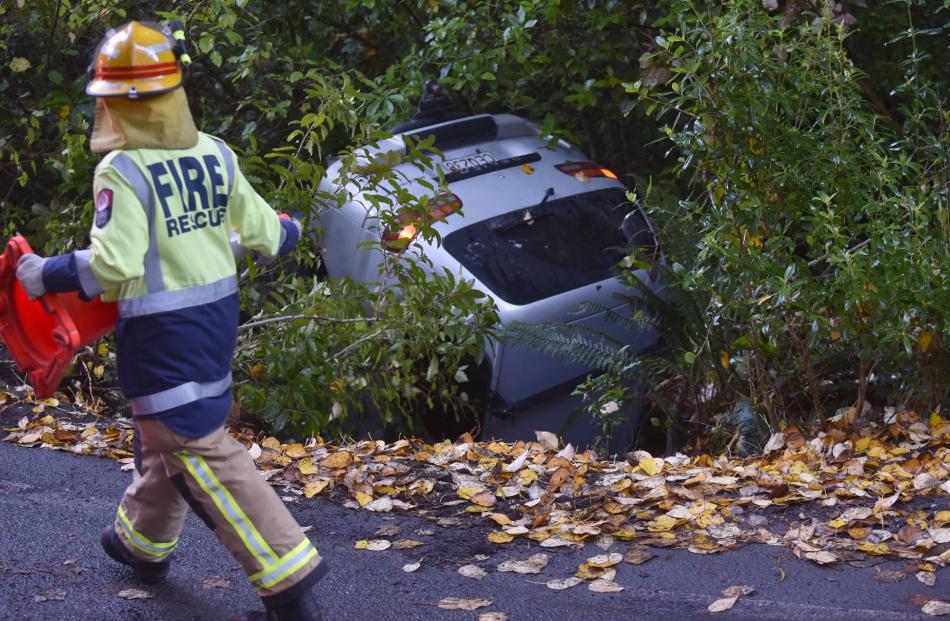Emergency services respond after a Mitsubishi Delica skidded on black ice at the intersection of...