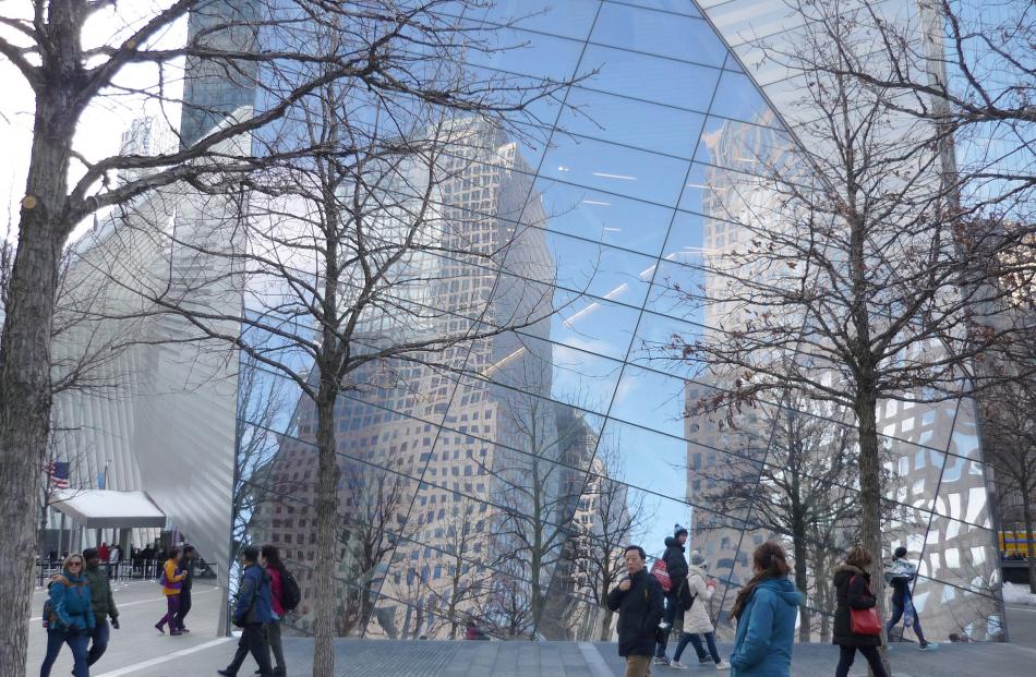 Buildings are reflected on the glass exterior walls of the 9/11 Memorial Museum. 