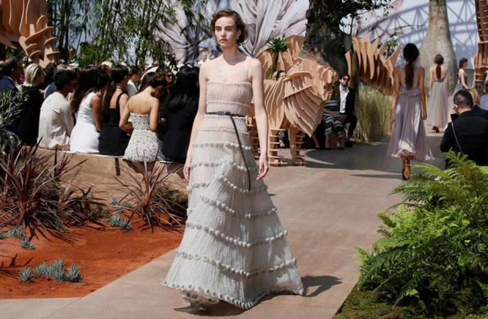 The collection mixed hard and soft and featured classical feminine silhouettes like this tiered floor-length gown. Photo: Reuters