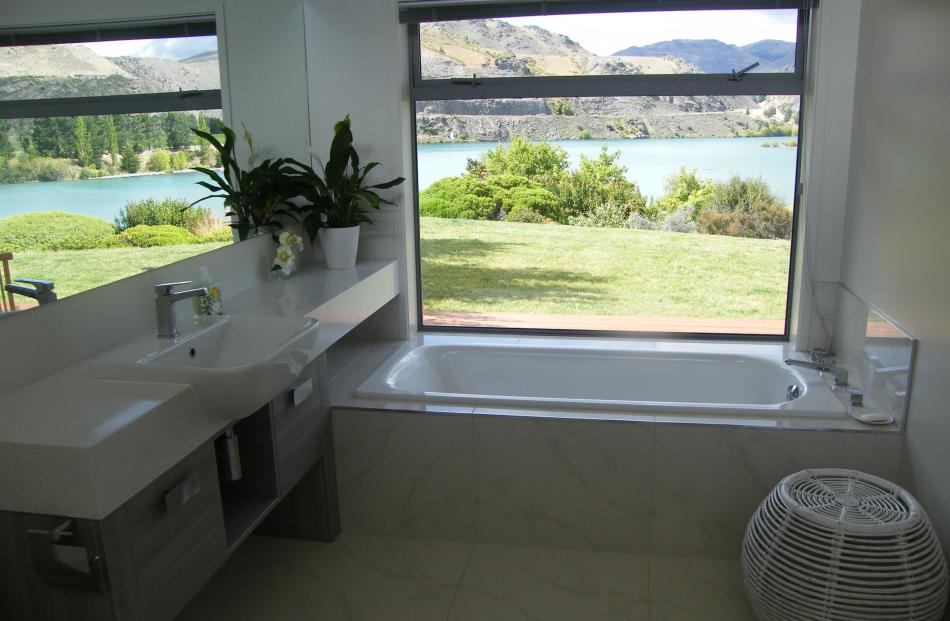 The view to Lake Dunstan is reflected in the bathroom mirror.