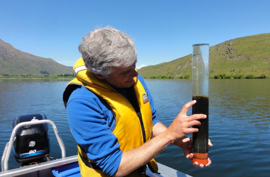 Dr Schallenberg with sediment core retrieved to study in-lake phosphorus recycling in 2014. ...