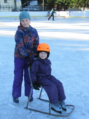 Sisters Amelia (10, left) and Zara (5) Dickey, of Cromwell, take a spin on the Naseby skating rink on Saturday.