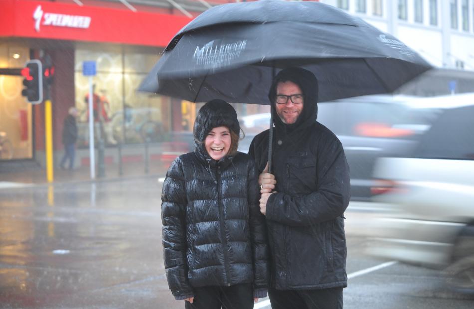 Stella and Brent Charnley, of Dunedin, smile in the rain in lower Stuart St. Photo: Christine O'Connor
