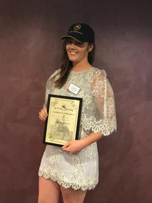 Lilly (18) receives a New Zealand Pony Club Young Achiever Award at the club's national conference last week. Photo: Supplied