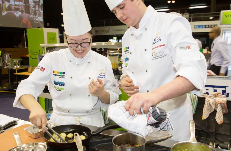 Otago Polytechnic Central Campus chefs Freda Zhang (left) and Sam Farr cook their way to a silver medal in this year’s national Nestle Toque d’Or student culinary competition. Photos: Supplied
