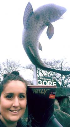 Megan McGregor holds Welly in front of Gore’s trout statue. Photos: Supplied