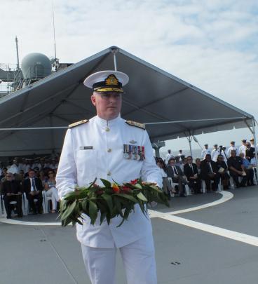 Commodore James Gilmore, representing New Zealand defence forces, prepares to lay a wreath in the...