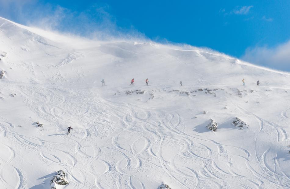 Skiers and snowboarders on Saturday at the Remarkables, before a 30cm top-up that night. Photos:...
