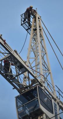 A worker on top of the crane on Saturday afternoon.