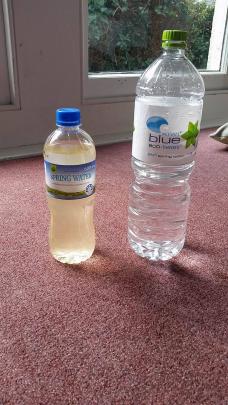 A photo of the Dunedin water from the contamination last night (left) and clean water. Photo: Simon Hill