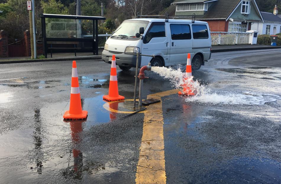 Dunedin City Council contractors flush water out of a water main on Malvern St in an effort to...