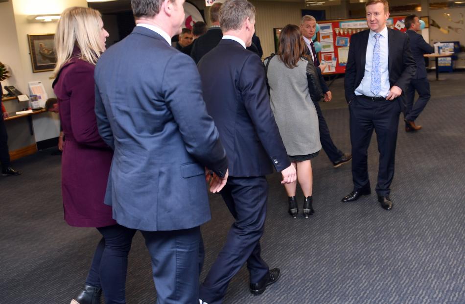The Prime Minister, Bill English, (centre), is led towards a rear exit from the hospital. Photo: Stephen Jaquiery