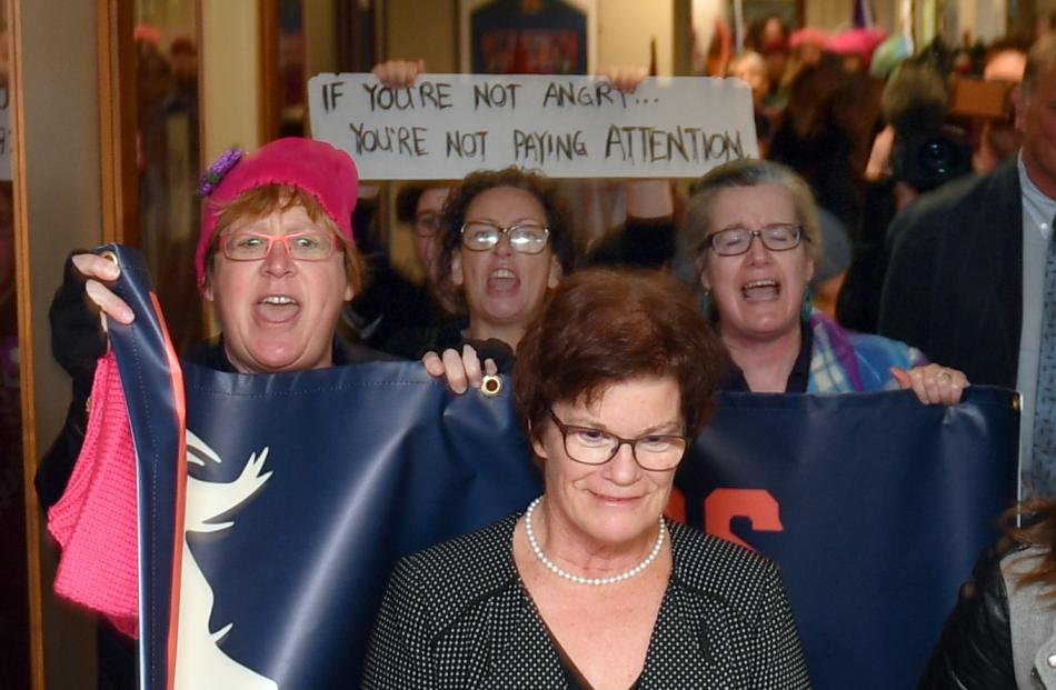 SDHB commissioner Kathy Grant is hounded by protesters as she follows the Prime Minister out of Dunedin hospital. Photo: Stephen Jaquiery