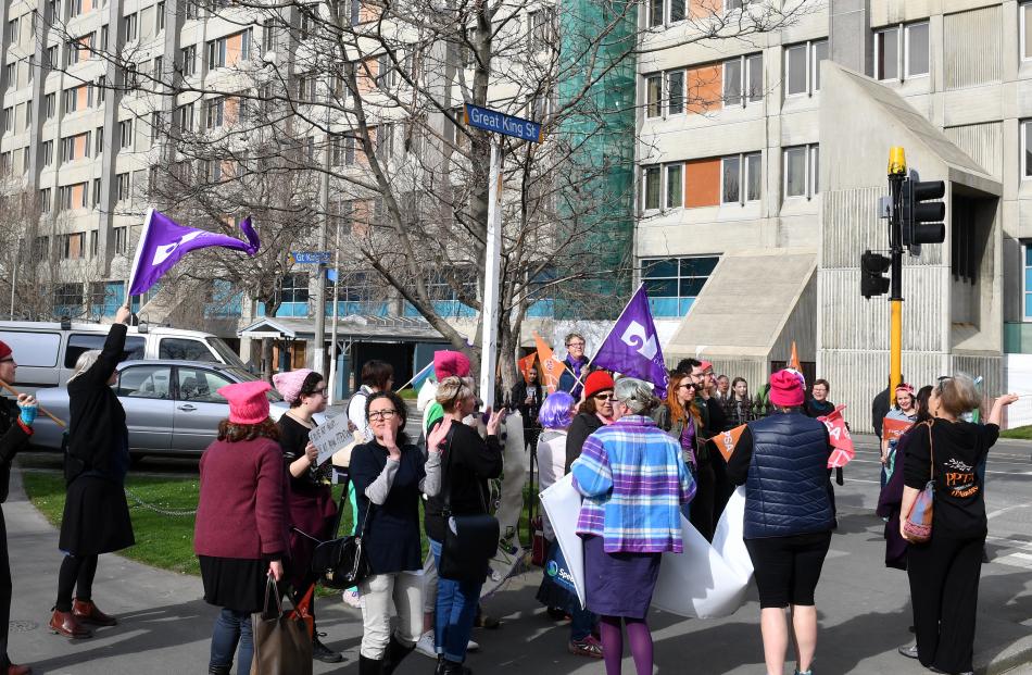 Protesters applaud themselves after chasing the Prime Minister out the rear entrance to the Dunedin public Hospital. Photo: Stephen Jaquiery