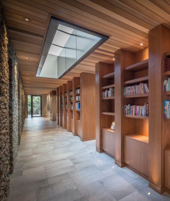 The gallery-style hallway also serves as a library. Photos: Simon Larkin
