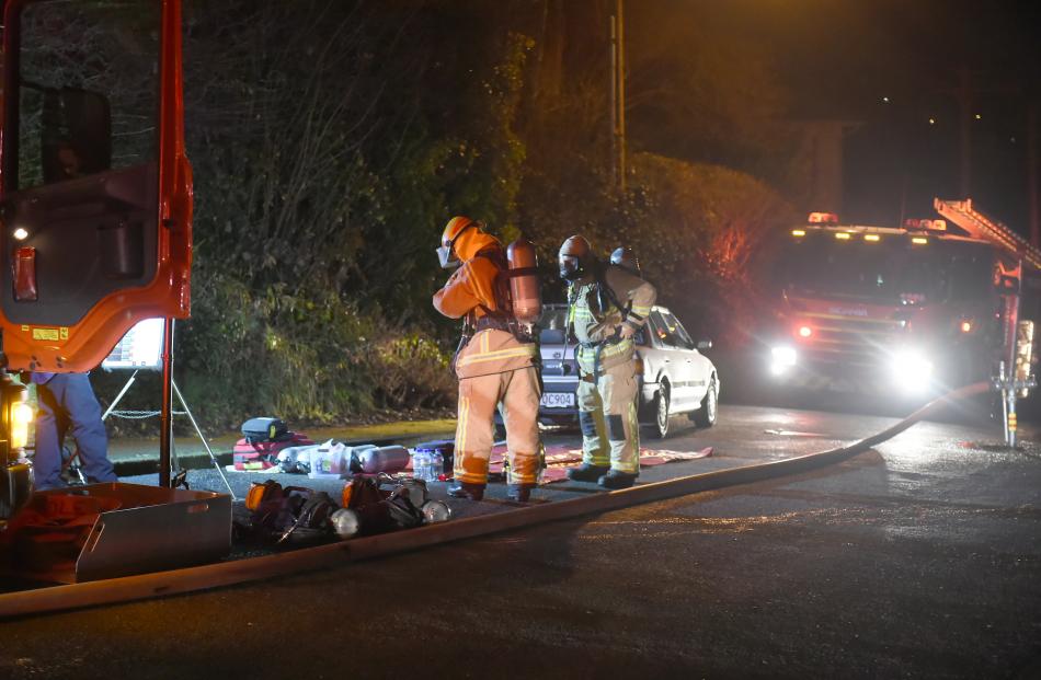 Fire and Emergency New Zealand firefighters prepare to enter the house.