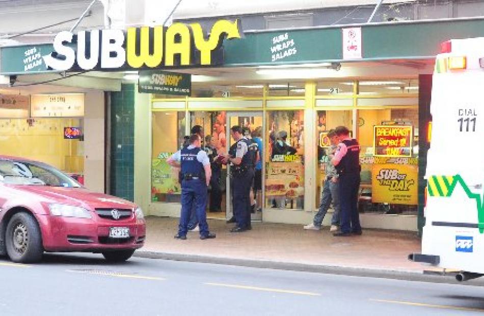St John Ambulance staff attend to the victim of a serious assault inside the Subway food outlet...