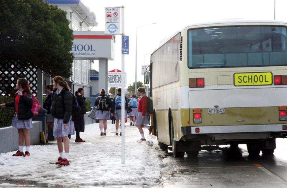Southland Girls High School students head to school after heavy snowfall closed many schools in...