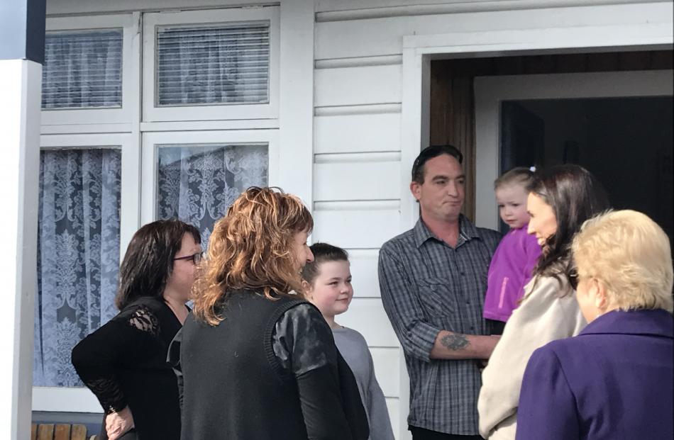 Jacinda Ardern talks to a St Kilda family who have been affected by flooding. Photo: Margot Taylor