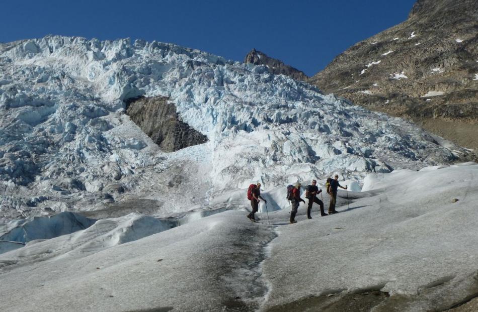 David Woods and other members of an expedition group start to climb an unexplored glacier in...